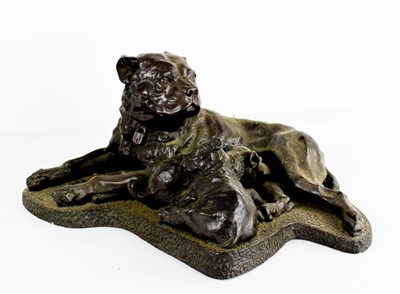 Lot 388 - A 20th century resin bronzed group of a dog...