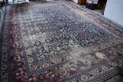 Lot 490 - A large middle eastern carpet, with borders of...