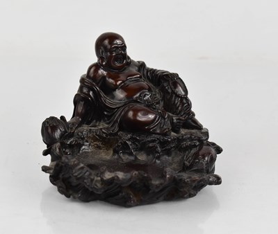 Lot 169 - A Chinese resin carved dish modelled as Buddha...