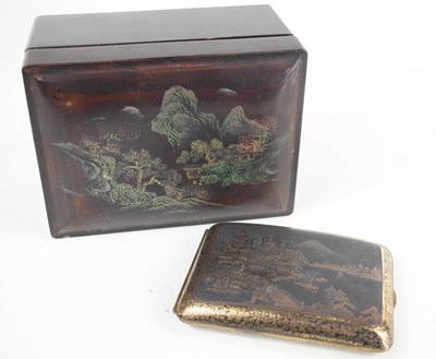 Lot 201 - A Japanese black and gold painted cigarette...