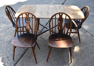 Lot 497 - An Ercol dining table and chairs.