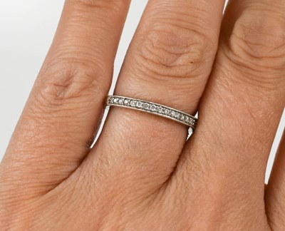 Lot 128 - A 9ct white gold and diamond half eternity...