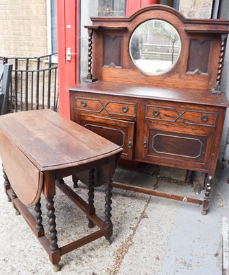 Lot 484 - A 1950s oak sideboard with mirrored back,...