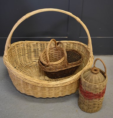 Lot 461 - An oversized wicker basket together with...