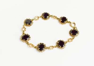 Lot 141 - A Victorian 9ct gold and garnet bracelet, set...