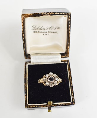 Lot 188 - A diamond and sapphire flowerhead ring, the...