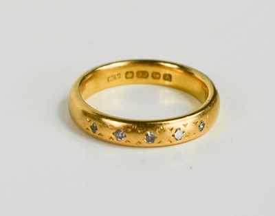 Lot 189 - A 22ct gold wedding band set with five small...