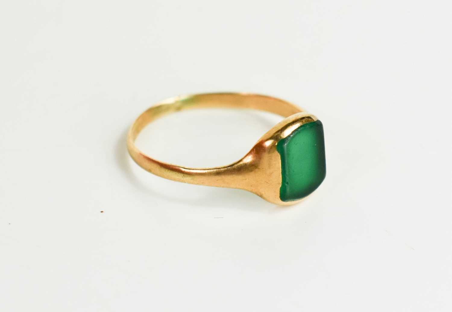 Lot 64 - A 9ct gold and green stone ring, likely green...