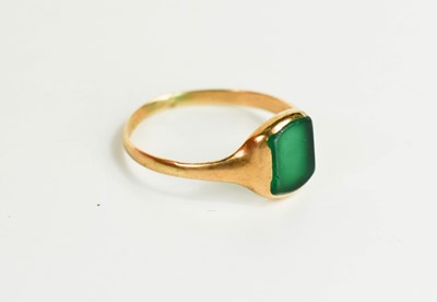 Lot 64 - A 9ct gold and green stone ring, likely green...