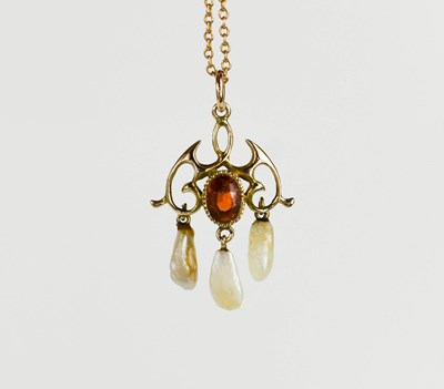 Lot 62 - An Edwardian scroll pendant on chain, set with...