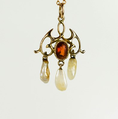 Lot 62 - An Edwardian scroll pendant on chain, set with...