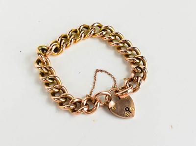 Lot 239 - A 9ct gold curb link charm bracelet, with...