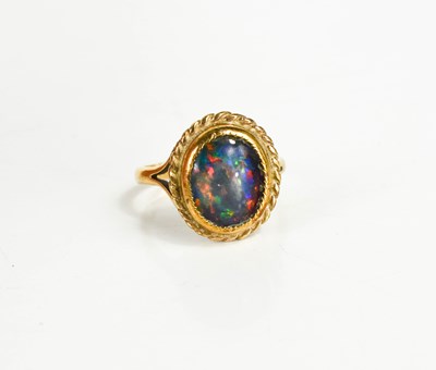 Lot 98 - A 9ct gold ring, set a black opal in a rope...