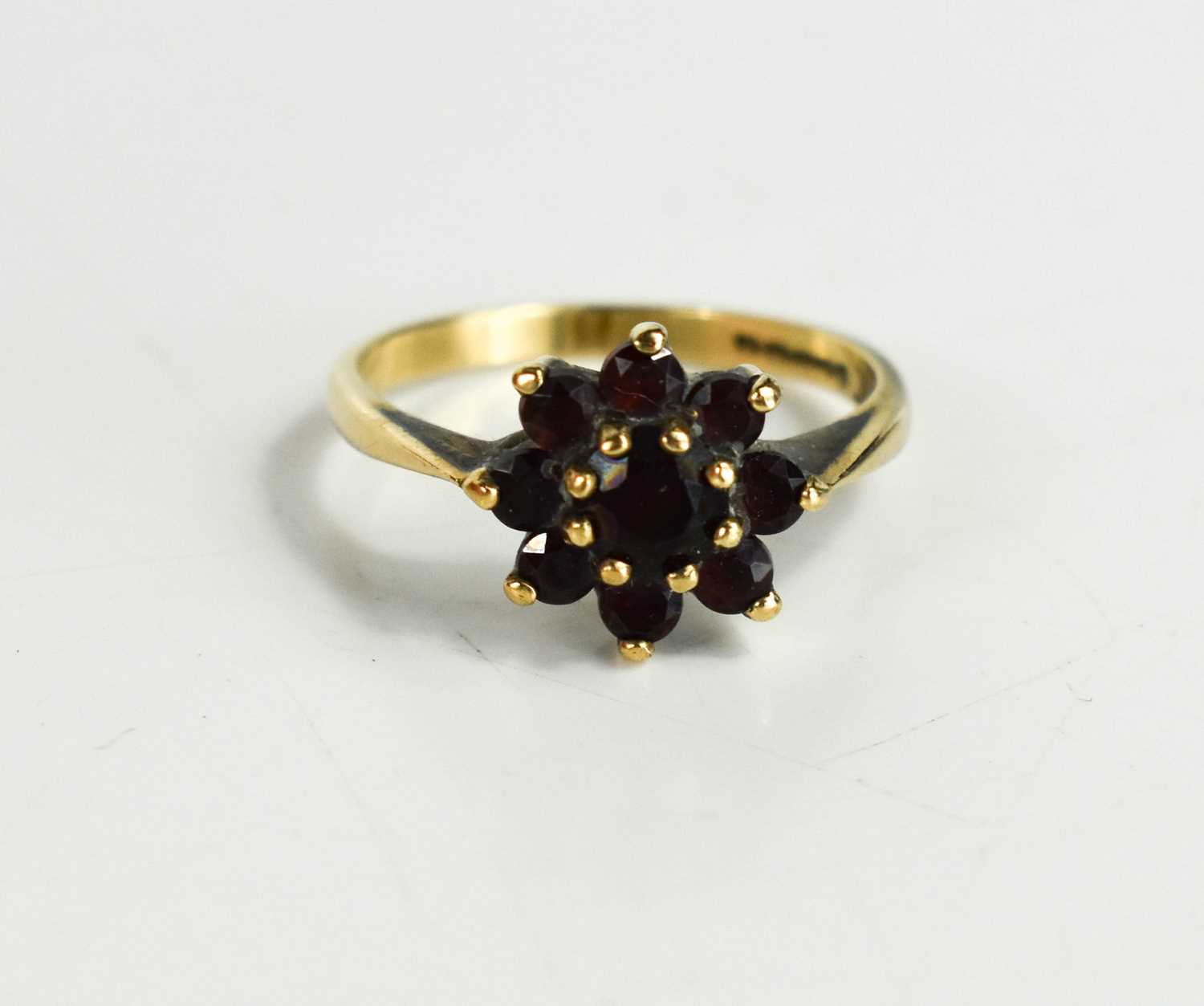 Lot 50 - A 9ct gold and garnet flowerhead ring, set...