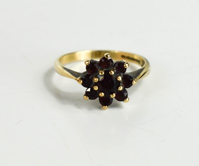 Lot 58 - A 9ct gold and garnet flowerhead ring, set...
