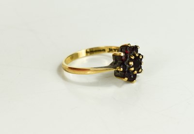 Lot 58 - A 9ct gold and garnet flowerhead ring, set...