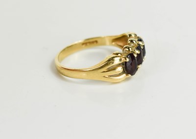Lot 60 - A 9ct gold and garnet three stone ring, size L,...