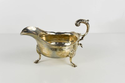 Lot 416 - A silver sauce jug, with scrolled auricula...