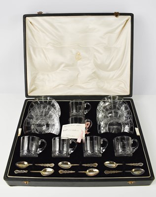 Lot 404 - A set of six glass coffee cans and saucers,...