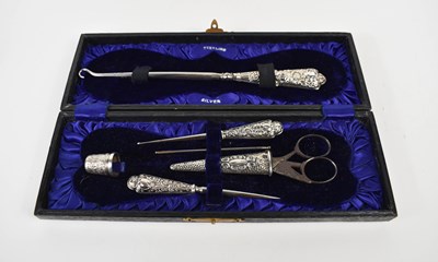 Lot 133 - An Edwardian silver mounted sewing set with...