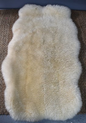 Lot 484 - A sheepskin rug, oval shape, 160cm.