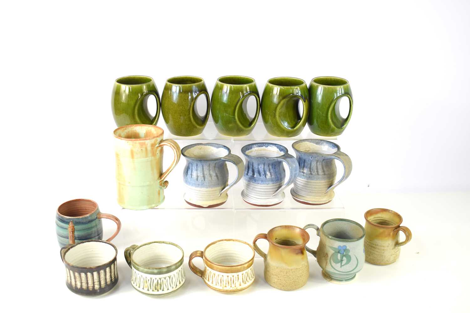 Lot 35 - A collection of studio pottery mugs to include...
