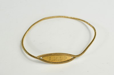 Lot 77 - A 9ct gold name bangle, with twist detail,...