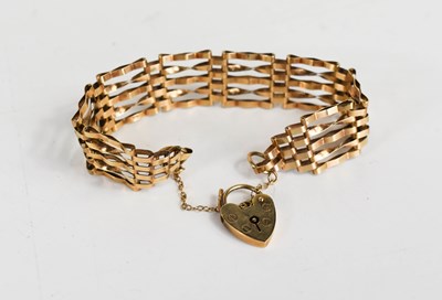 Lot 167 - A 9ct gold gate-link charm bracelet with heart...