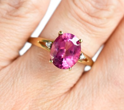 Lot 125 - A pink sapphire and diamond set dress ring, in...