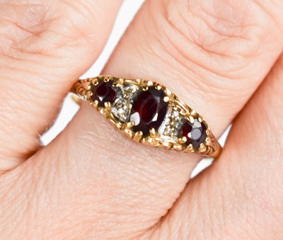 Lot 74 - A 9ct gold three stone ring, set with...