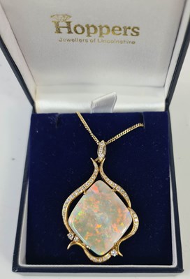 Lot 281 - A large opal pendant, the rectangular single...