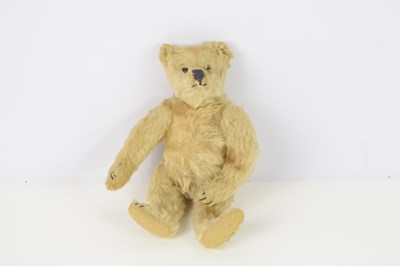 Lot 409 - A vintage small mohair, straw filled bear,...