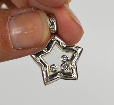 Lot 5 - An 18ct white gold floating diamond star...
