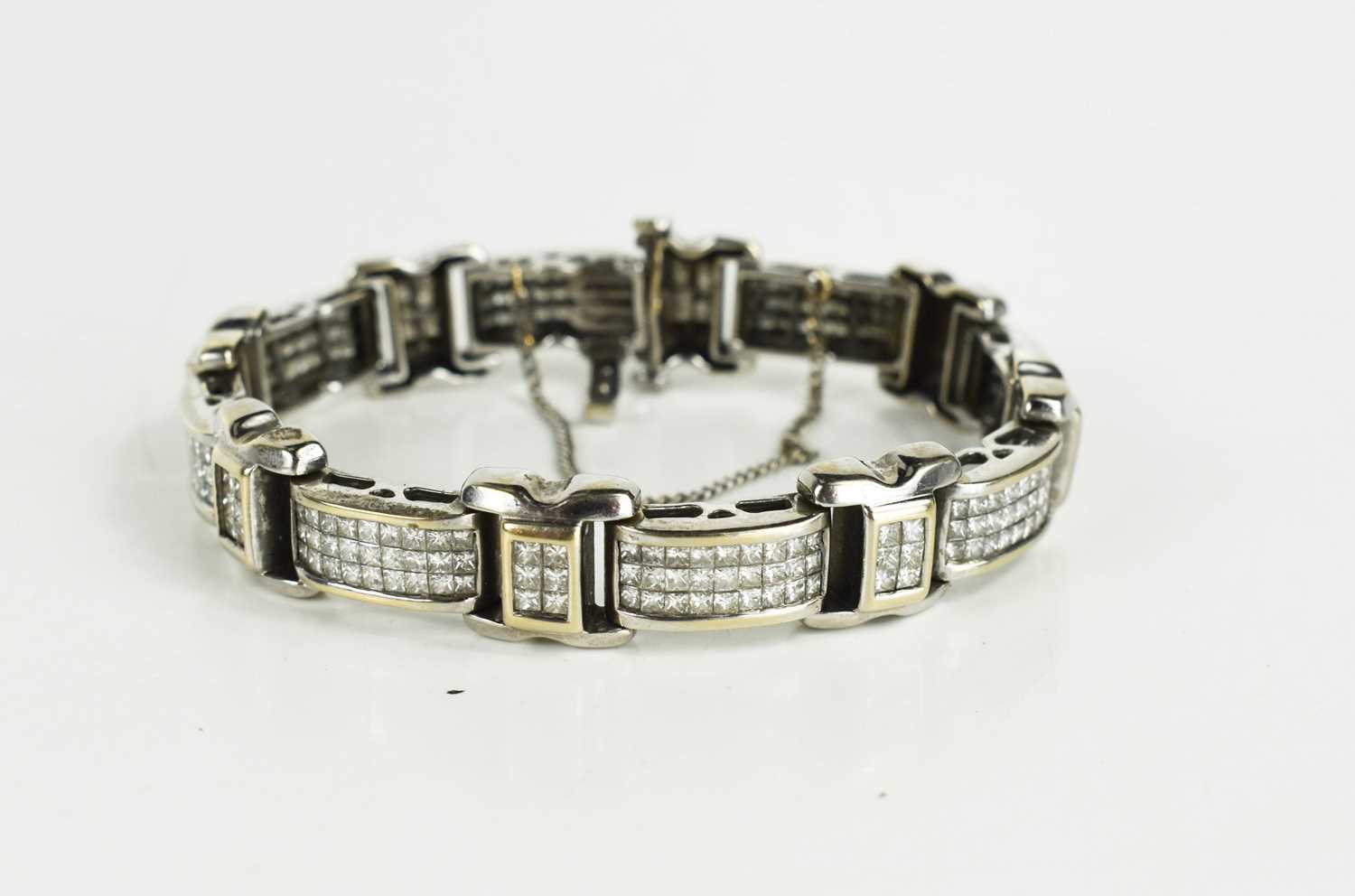 Lot 10 - An 18ct white gold and diamond set bracelet,...