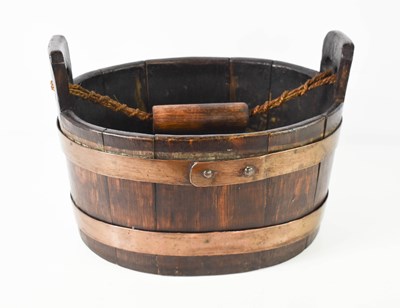 Lot 450 - A 19th century oak coopered barrel form basket,...