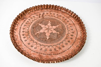 Lot 525 - An Arts & Crafts copper charger, embossed...