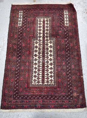 Lot 487 - A Middle Eastern prayer rug, with red ground...