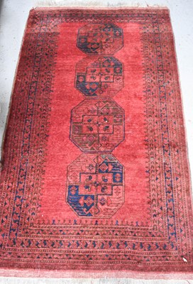 Lot 489 - A Persian rug, with red ground and four blue...