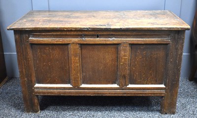 Lot 558 - An 18th century oak coffer, two plank top,...