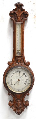 Lot 298 - A late Victorian carved oak aneroid banjo...