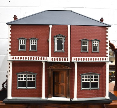 Lot 410 - A large wooden dolls house modelled as an...