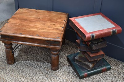 Lot 552 - A side table in the shape of a stack of books...