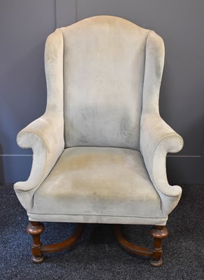 Lot 561 - A 19th century wingback armchair, with walnut...