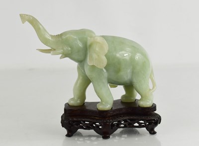 Lot 156 - A Chinese jade carving of an elephant raised...
