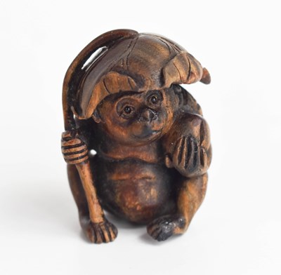 Lot 156 - A Japanese carved wooden netsuke of a monkey...