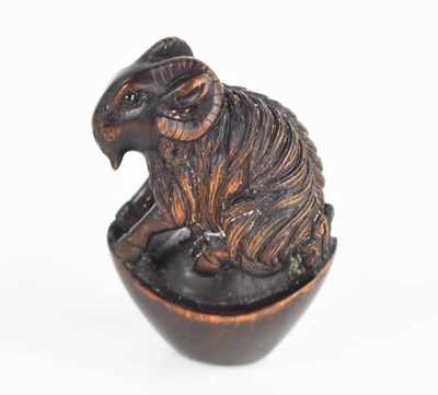 Lot 157 - A Japanese carved wooden netsuke of a ram,...