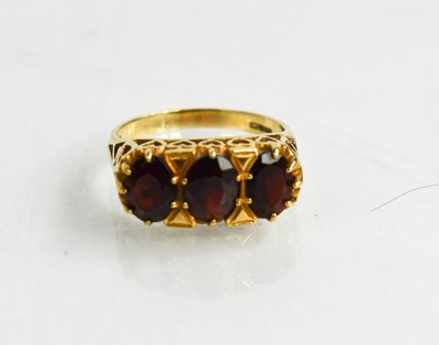 Lot 149 - A 9ct gold and garnet three stone ring, size M,...