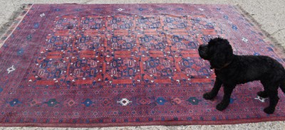 Lot 493 - A Middle Eastern rug with red ground, 214cm by...