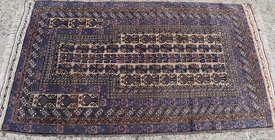 Lot 491 - A Middle Eastern prayer rug, with dark blue...