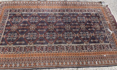 Lot 492 - A Middle Eastern orange and blue ground rug.